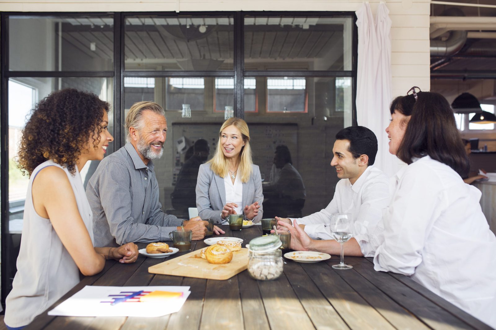 Agents talking over coffee at a working lunch