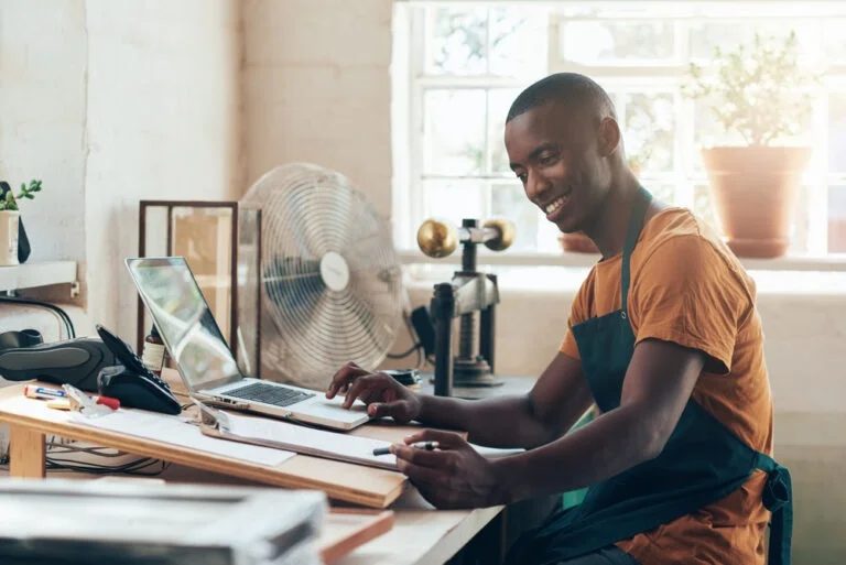A small business owner working at a laptop